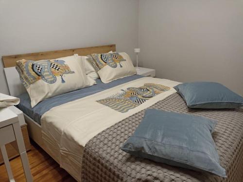 a bedroom with a bed with pillows on it at 2 Bedroom Family Apartment with Free Parking in Thessaloniki