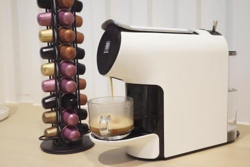 a coffee maker with a glass next to it at Blue Skyline Hotel in Patong Beach