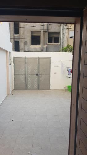 an empty courtyard with two garages in a building at Sweet home three bedroom house in Sousse
