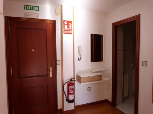 a bathroom with a fire hydrant next to a door at Eguzkilore - Apartamento luminoso y soleado in Elizondo