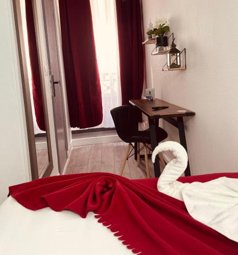a bedroom with a bed with a swan on it at HOTEL LOUVAIN in Paris