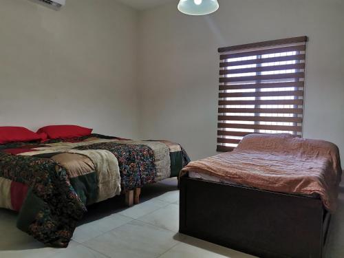 A bed or beds in a room at Hidden Hacienda with private pool