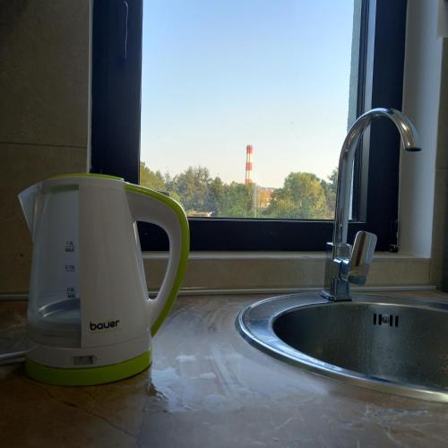 a coffee cup sitting on a counter next to a sink at RIVIJERA CITY in Belgrade
