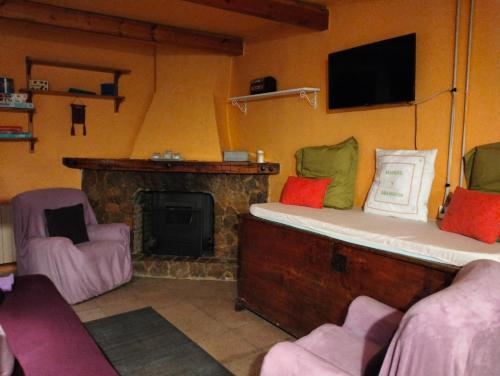 a living room with a couch and a fireplace at Casa Manuel y Ana María. 