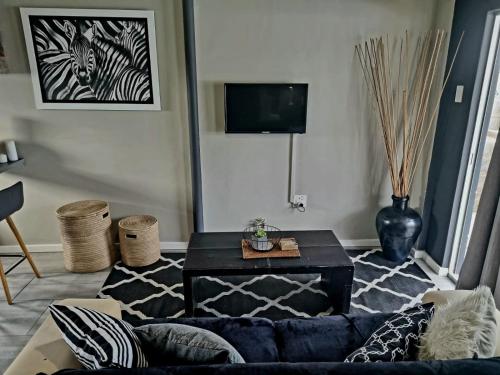a living room with a couch and a coffee table at Angel 8 AirBnB Apartment 1 in Robertson