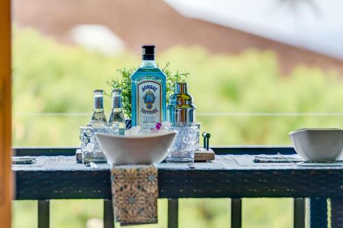 a bottle of gin sitting on top of a table at Kaanapali Plantation 58 · KPL 58 Spacious 2BD Plantation Home Ne in Lahaina