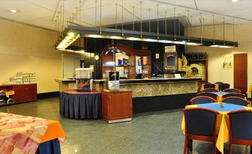 a restaurant with a bar with chairs and a counter at Olympik Tristar in Prague