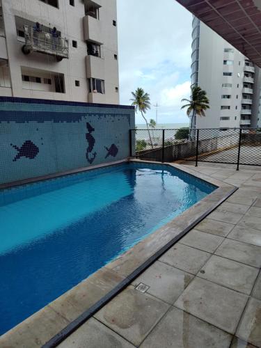 a swimming pool in front of a building at BOA VIAGEM FLATS APTO 201 in Recife