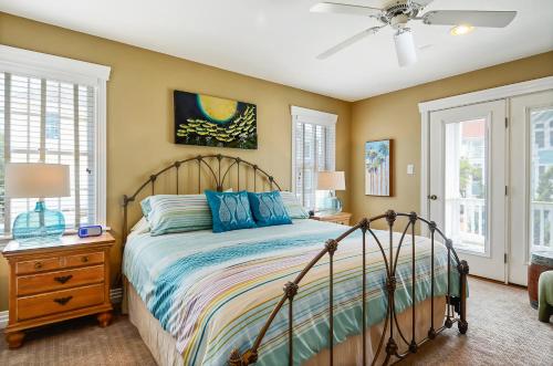 a bedroom with a bed and a ceiling fan at 1606 - Shades of Sand in Corolla