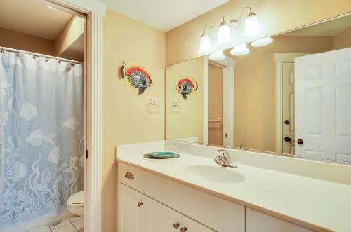a bathroom with a sink and a mirror at 1606 - Shades of Sand in Corolla