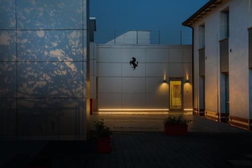 a building with a door with a light on it at Hotel Maranello Village in Maranello