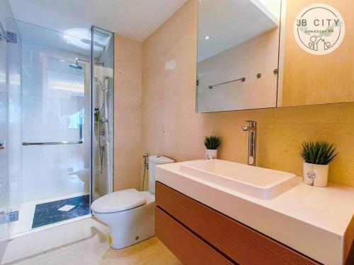 a bathroom with a toilet and a sink and a shower at Pine Tree HardRock Suites by JBcity Home in Kampong Baharu