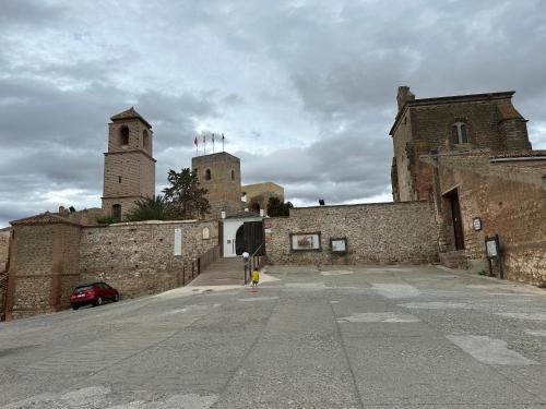 a person standing in front of a building with two towers at MiraSierraHome... Tú hogar de vacaciones! in Alora