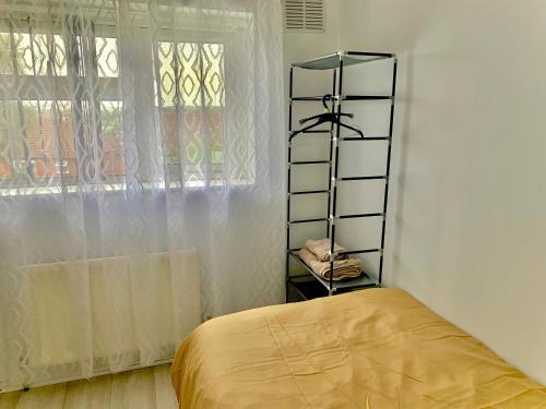 a bedroom with a bed and a shelf next to a window at Single room bentilee in Bucknall