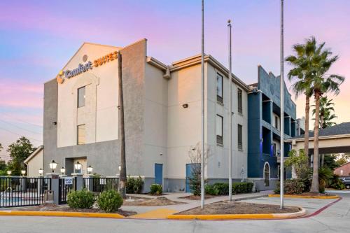 a building with a sign on the side of it at Comfort Suites Houston NW - Vintage Park in Houston