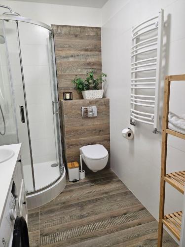 a bathroom with a toilet and a shower and a sink at MIRA Apartment in My Center in Szczecin