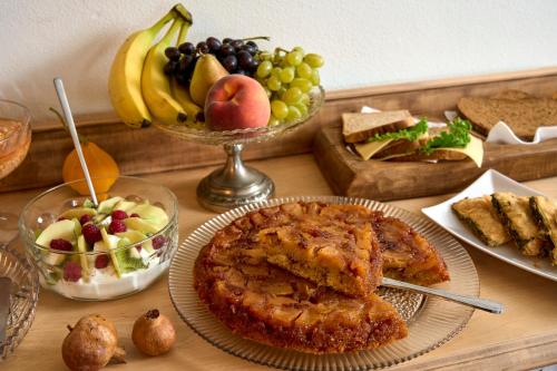 a table topped with plates of food and fruit at Thalassoxyla Portaria in Portariá