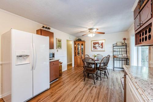 a kitchen with a white refrigerator and a table with chairs at Kelly's Comfortable Quinton Home in Quinton