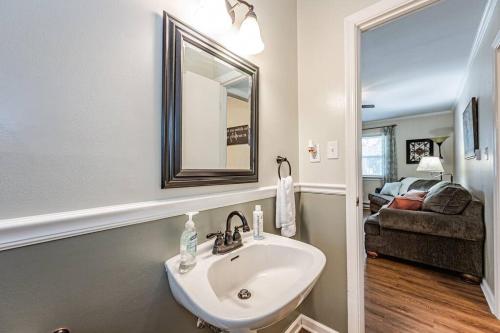 a bathroom with a sink and a mirror and a couch at Kelly's Comfortable Quinton Home in Quinton