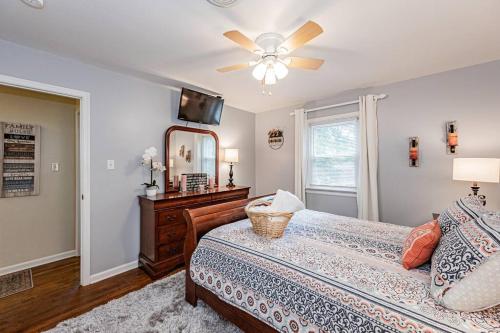 a bedroom with a bed and a ceiling fan at Kelly's Comfortable Quinton Home in Quinton