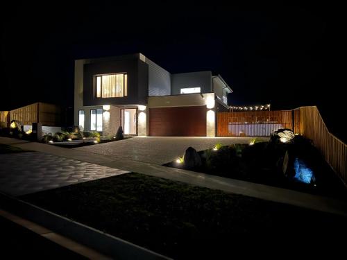 a house lit up at night with its lights at Dreamviews at Metung in Metung