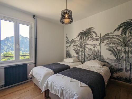 two beds in a bedroom with palm trees on the wall at Maison rénovée avec piscine, parc arboré et proche de la gare à Chamalières-sur-Loire - FR-1-582-469 in Chamalières-sur-Loire