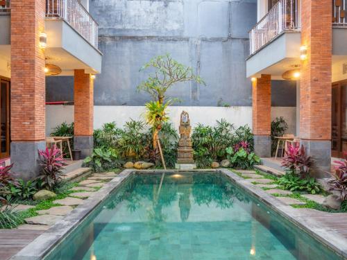 a swimming pool in the middle of a building at Arumasta Ubud in Ubud
