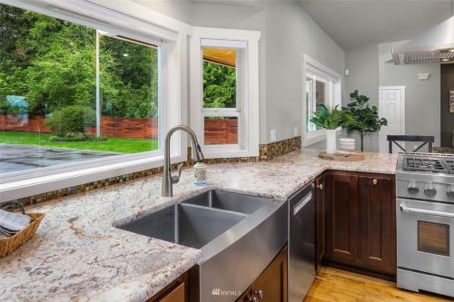 a kitchen with a sink and a window at New Lighthouse Port Susan View House Camano in Bretland