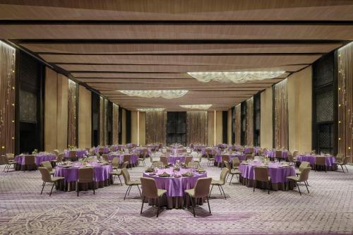 a large banquet hall with purple tables and chairs at Renaissance Bali Nusa Dua Resort in Nusa Dua