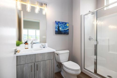 a bathroom with a toilet and a sink and a shower at Brand New Fully Updated Condo 904 in Anacortes in Anacortes