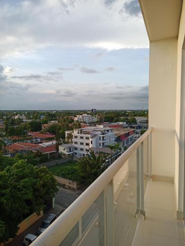 a balcony with a view of a city at Simply the most comfortable place next to Boca Chica beach in Boca Chica