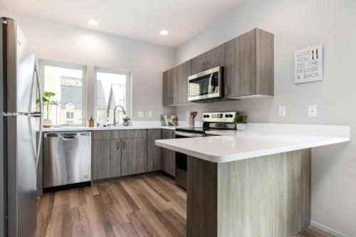 a kitchen with wooden cabinets and a white counter top at Brand New Fully Updated Condo 912 in Anacortes in Anacortes