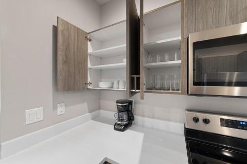 a kitchen with a stove and a microwave at BRAND NEW Fully Updated Condo 918 in Anacortes in Anacortes