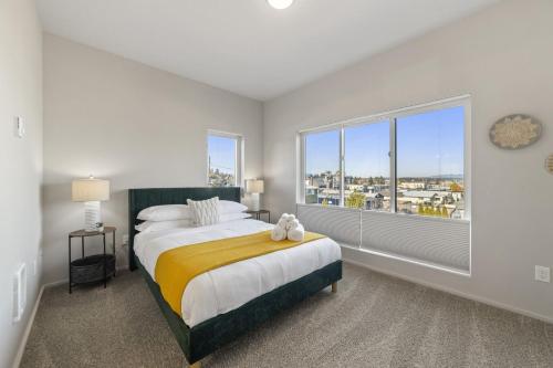 a bedroom with a large bed and a large window at BRAND NEW Fully Updated Condo 918 in Anacortes in Anacortes