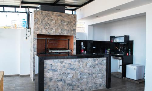 a kitchen with a stone fireplace in a room at Morada in Tacna