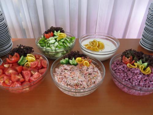 a table topped with bowls of different types of food at Olympik Tristar in Prague