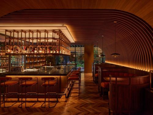 a bar in a restaurant with bar stools at Dusit Thani Kyoto in Kyoto
