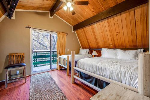 Dos camas en una habitación con ventana. en Mountain & Ski Slope View Cabin 3bd/3bth Sleeps 10, en Big Bear Lake