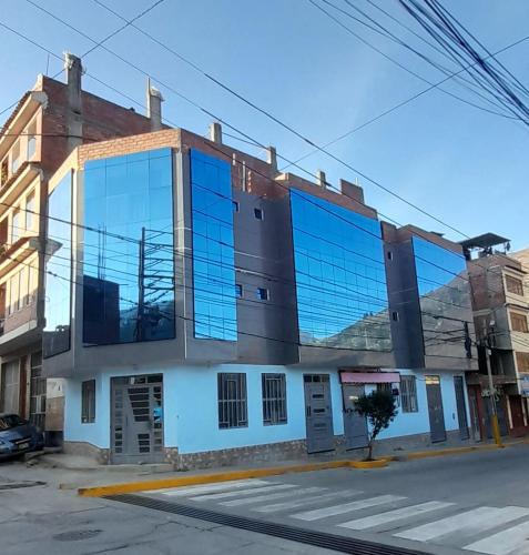 a large blue building on the side of a street at Hostal Pura Casta in Carhuaz