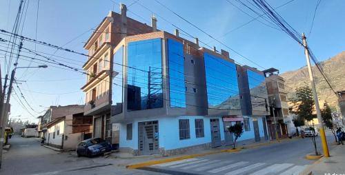 a building with glass windows on a street at Hostal Pura Casta in Carhuaz
