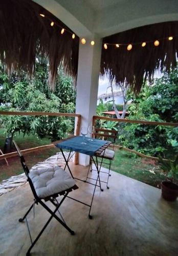 a patio with a blue table and two chairs at Quédate Aquí in Las Galeras