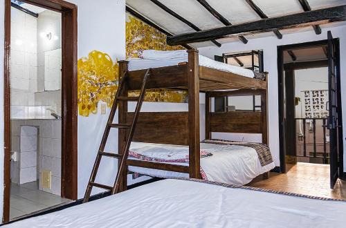a bedroom with two bunk beds in a room at Villa Candelaria Hostel in Bogotá