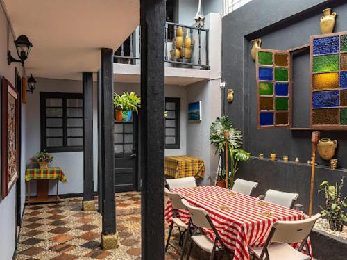 a table and chairs on a patio with a table and a table at Villa Candelaria Hostel in Bogotá