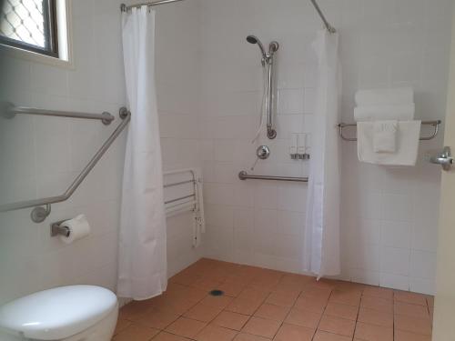 a bathroom with a toilet and a shower at Carriers Arms Hotel Motel in Maryborough