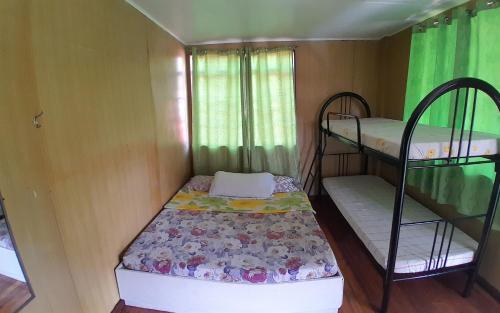 a small room with two bunk beds in it at Amara Transient House - Homestay in Baguio