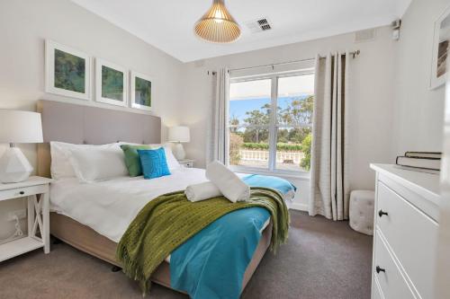 a bedroom with a bed and a large window at Mid Century 4 Bedroom Getaway in Barossa Vineyard in Nuriootpa