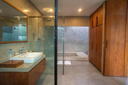 a bathroom with a shower and a sink and a tub at Ziva a Boutique Villa in Seminyak