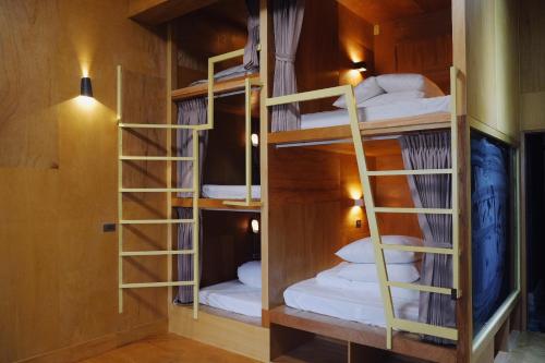 a room with three bunk beds in it at MUSEaUM 沐洋人 in Hengchun