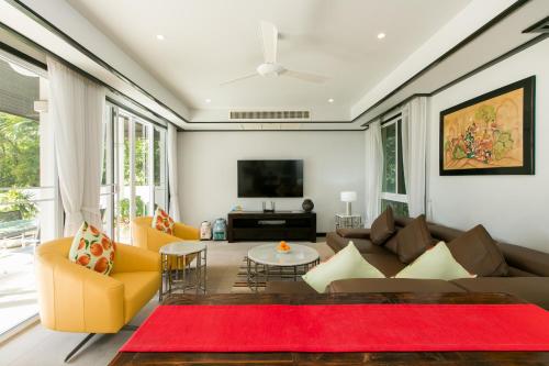 a living room with a couch and a tv at Katamanda Villa Mila A1 near Kata Beach in Kata Beach