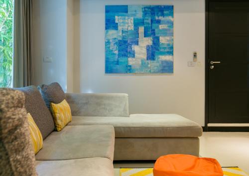 a living room with a couch and a painting at Katamanda Villa Mila A1 near Kata Beach in Kata Beach